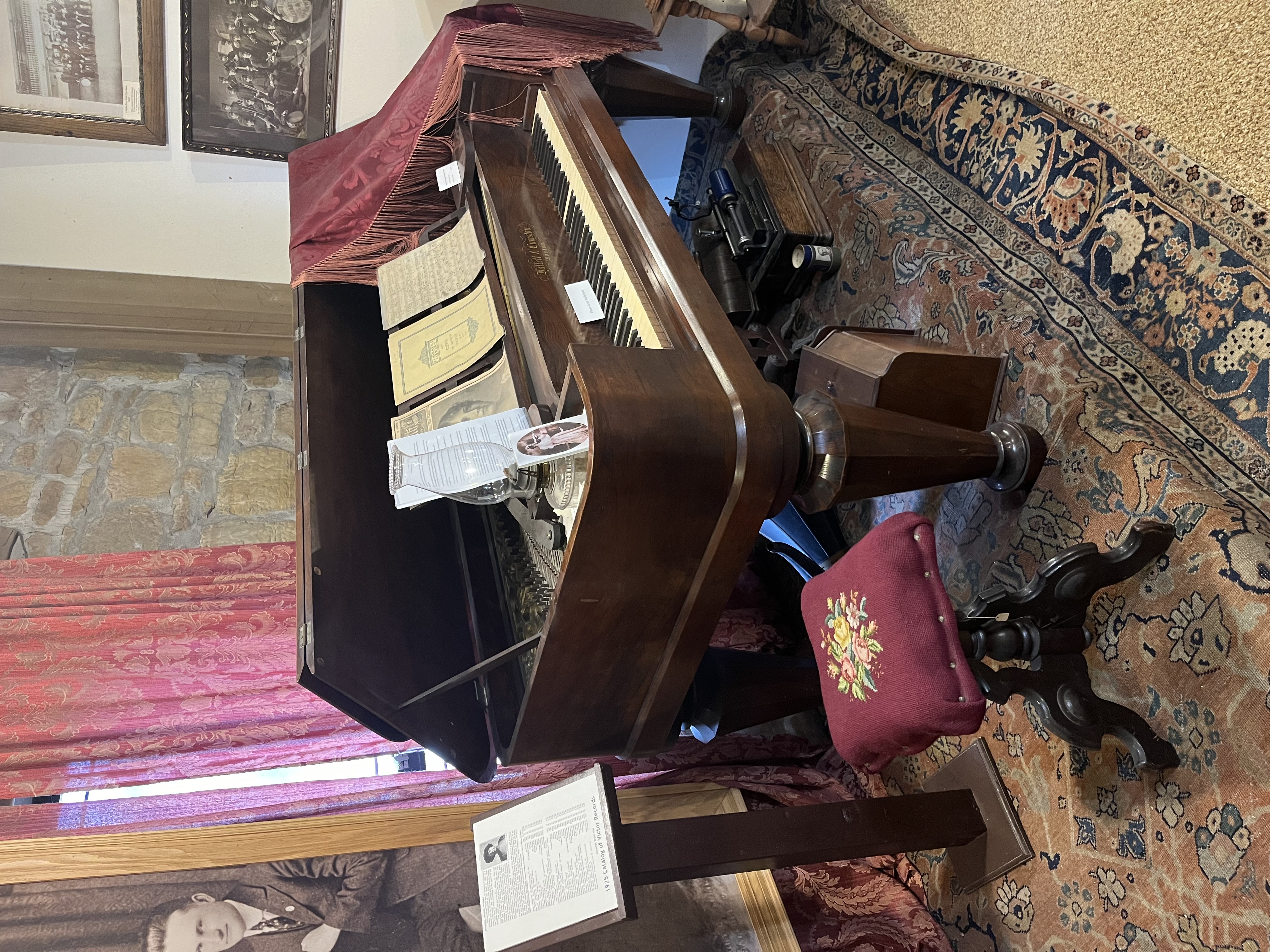 The Gunn family piano, a Hallett & Cumston square grand, open on display at the LaSalle County Historical Society Museum in Utica, Illinois, with a needlepoint stool in front.